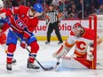 Calgary Flames goaltender Jacob Markstrom makes a save as Montreal Canadiens forward Christian Dvorak watches at Bell Centre in Montreal on Monday Dec. 12, 2022.