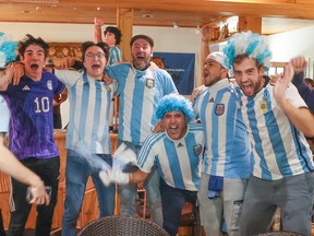 Argentina fans at the Calgary Tennis Club celebrate their team's 3-0 World Cup semifinal victory over Croatia on Tuesday, Dec. 13, 2022.