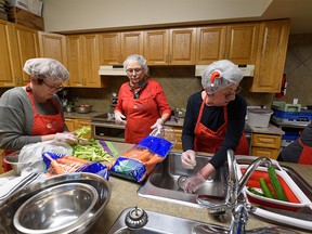 Brown Bagging for Calgary's Kids volunteers prepare sandwiches for school children at the Emmanuel Christian Reformed Church kitchen on Wednesday, December 21, 2022.