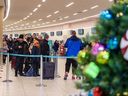Passengers wait to check-in with WestJet at Calgary International Airport (YYC) as extreme cold in Calgary and wintry conditions in other parts of Canada caused numerous flight delays and cancellations on Thursday, December 22, 2022.  Azin Ghaffari/Postmedia