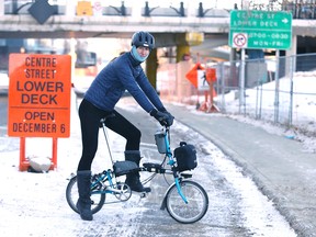 Brett Bergie poses near Center St and Riverfront Ave SE in Calgary on Sunday, December 4, 2022. The lower portion of the bridge is scheduled to open in the near future.