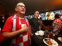 Croatia fans sing the national anthem as they join other fans to watch the World Cup semi-final at Limericks on Macleod Trail SW in Calgary, Tuesday, December 13, 2022. 