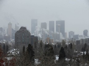 The downtown Calgary skyline is obscured by fog, exhaust and cloud on a cold winter day on Tuesday, December 20, 2022.