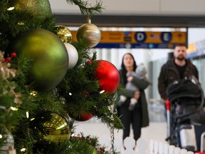 Travelers move through Calgary International Airport on Tuesday, Dec. 20, 2022. Weather issues across Canada have caused flight delays and cancellations.