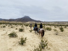 An image of people riding horseback at Lajitas Resort in Texas.