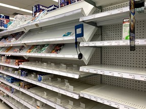 Shelves waiting to be restocked with cold medicine.