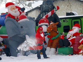 Carlos Herreria clears the snow in front of his house in Bowness on Thursday 22 December 2022.