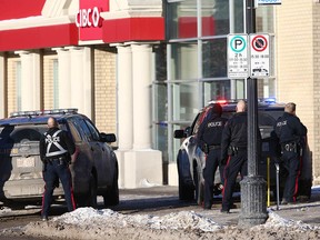 Police surround a CIBC branch on 17th Avenue SW on Friday.  A man was arrested after a 90-minute standoff.