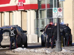 Police surround a CIBC branch on 17th Avenue SW on Friday. A man was arrested after a 90-minute standoff.