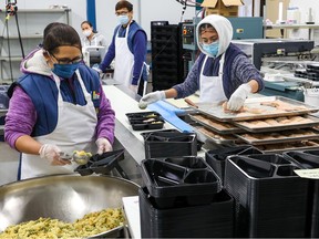 Staff prepare meals at Calgary Meals On Wheels on Wednesday, November 30, 2022.