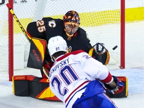 Calgary Flames goaltender Jacob Markstrom reaches out for this shot by Montreal Canadiens forward Juraj Slafkovsky at the Scotiabank Saddledome in Calgary on Thursday, Dec. 1, 2022.