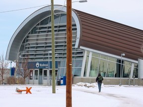 A pedestrian crosses an undeveloped section of land towards the Westbrook CTrain station near where Ernest Manning High School once was on Thursday, December 8, 2022. Calgary city council is currently looking at a local area plan for the Westbrook Communities.