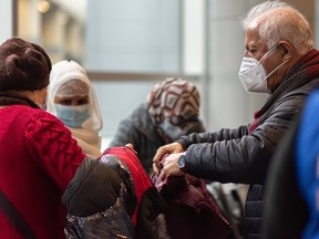 Fariborz Birjandian, CEO of Calgary Catholic Immigration Society (CCIS), assists Afghan refugees at the Calgary International Airport (YYC) upon their arrival earlier this year.