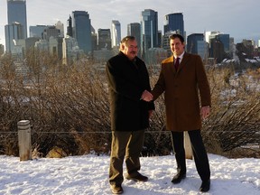 Kevin Gregor, left, of Boyden Calgary and Bryan Arthur, of DHR Global, shake hands on their new relationship.