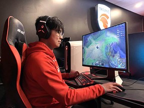 Competitive player Andrew Tran tests out the new esports computer area at SAIT in Calgary.