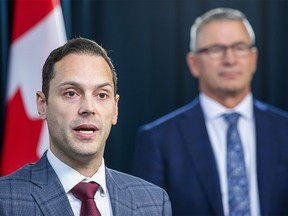 Affordability and Utilities Minister Matt Jones speaks as Treasury Board President and Finance Minister Travis Toews listens as he shares details on legislation aimed at supporting Albertans during the affordability crisis on Wednesday, December 7, 2022 in Edmonton.