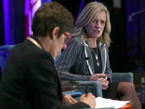Deborah Yedlin, CEO of the Calgary Chamber of Commerce, chats with NDP Leader Rachel Notley, right, during Thursday's lunch.