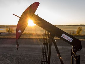 A pump jack pulls oil and gas from a wellhead as the sun sets near Calgary, Alta., Sunday, Oct. 9, 2022.