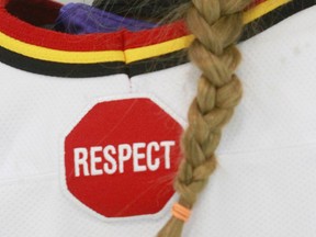 A symbol of respect is displayed on a hockey jersey after Bantam 2C action at Max Bell Center on Saturday, January 18, 2014.