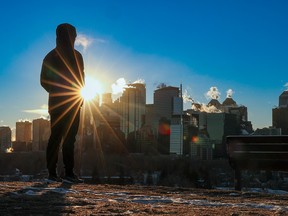 Michael Williams takes in the sunrise over the downtown skyline during a recent cold snap.
