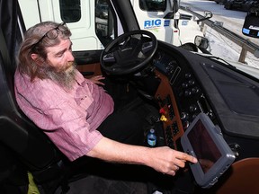 Greg Wolfe, safety and compliance supervisor with RIG Logistics, shows an electronic log display installed in a truck.