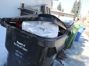 Full black bins were waiting in Calgary's northwest community of Capital Hill on Wednesday, March 20, 2019.