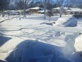 A car sits blanketed in snow on a driveway, Sunday, Dec. 25, 2022, in Amherst, N.Y.