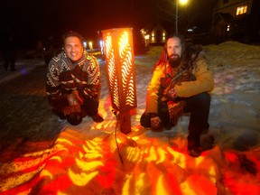 L-R, Artist, Adrian Stimson and Dylan Toymaker with their new art installation called Light the Night at the newly reopened Woodlands area of Alexandria Park using Blackfoot pictographs on lanterns that line a winding path in the wooded area near the Currie Barracks in Calgary on Thursday, January 12, 2023.