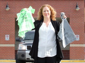 Sage Pullen McIntosh, Calgary Co-op spokesperson, poses with biodegradable bags, left, that replaced traditional plastic bags, right, at grocery stores in 2019.