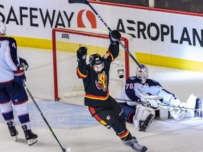 Calgary Flames forward Andrew Mangiapane celebrates teammate Dillon Dube’s overtime goal against the Columbus Blue Jacketsat Scotiabank Saddledome in Calgary on Monday, Jan. 23, 2023.
