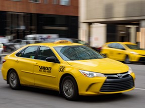 A Checker taxi cab proceeds down a street in downtown Calgary on Thursday, January 26, 2023.