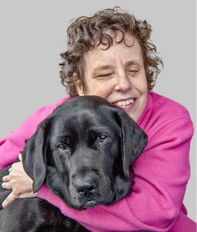 Kim Kilpatrick hugs guide dog Tulia. Photo, Joan Anderson