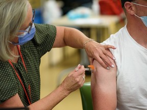 Registered nurse Kate gives a flu shot at Richmond Road Diagnostic and Treatment Center on Monday, October 17, 2022.