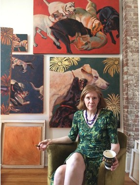 Visual artist Karen Bailey with some of the paintings she created of guide dogs that provide a backdrop for the Vertigo Theatre show Raising Stanley/Life with Tulia.