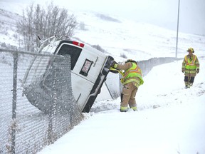 Calgary firefighters secure a van which rolled over on Shaganappi Trail north of John Laurie Blvd N.W. on Friday. There were no injuries in the accident.