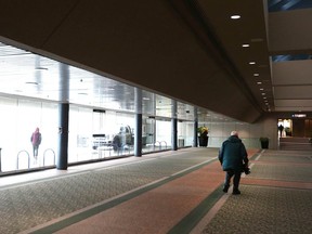 Pedestrians are shown inside the Municipal Building in Calgary Friday, Jan. 27, 2023. All chairs were removed to make way for a Chinook Blast event when this photo was taken.