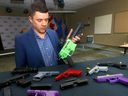 Acting Staff Sgt.  Ben Lawson with the firearms investigation unit displays some of the 3D guns seized by Calgary police on Thursday, Jan. 19, 2023.