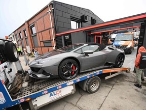 Police transport a Luxury car on a platform out from the site of "The Hustlers University" belonging to controversial influencer Andrew Tate and his brother in Bucharest on January 14, 2022.