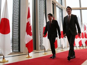 Prime Minister Justin Trudeau and Japanese Prime Minister Kishida Fumio walk together after a news conference Thursday in Ottawa.