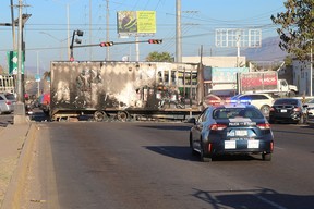 Wreckage from a burned truck blocks a street in Culiacan, northwest of Mazatlan, on Friday.