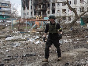 British volunteer Christopher Parry walks next to a residential building damaged by a military attack in the town of Bakhmut, Donetsk region, Ukraine, on January 5.