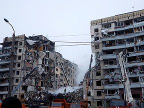 Emergency personnel work at the site where an apartment block was heavily damaged by a Russian missile strike, amid Russia's attack on Ukraine, in Dnipro, Ukraine January 15, 2023.