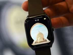 The iQIBLA Quran Watch, a smartwatch for Muslims featuring Quran Recitation, prayer times, and other conventional wearable features, is displayed during the Consumer Electronics Show (CES) in Las Vegas, Nevada, on January 7, 2023. (Photo by Patrick T. Fallon / AFP)