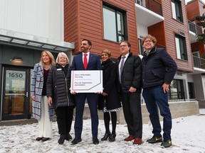 From left; Sue Tomney, CEO of YWCA Calgary, Sharon Carry YWCA Calgary board chair, Calgary Skyview MP George Chahal, Calgary Mayor Jyoti Gondek, Jeremy Nixon, Minister of Seniors, Community and Social Services and Ward 9 councilor Gian-Carlo Carra pose for a photo outside the YWCA's new affordable housing and an expanded crisis shelter in Inglewood on Wednesday, January 25, 2023.