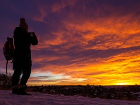 Calgarians enjoy a spectacular sunrise from the ridge in Renfrew on Thursday, December 8, 2022.
