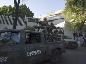 A heavily armed army convoy departs the prosecutor's building where Ovidio Guzmán, one of the sons of former Sinaloa cartel boss Joaquin "El Chapo" Guzmán, is in custody in Mexico City, Thursday, Jan. 5, 2023. The mayor of a Mexican city caught up in a wave of drug cartel violence last week wasted little time reassuring Canadians and other foreign visitors that his city is safe for travellers.