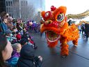 Dancers perform the traditional lion and dragon dance in Chinatown on Saturday.  More events will take place next weekend.