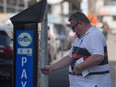 A man uses the City of Edmonton's EPark system.