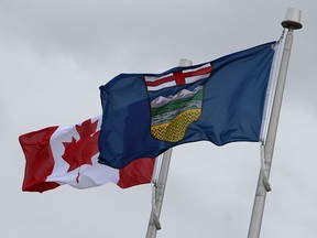 The flags of Alberta and Canada outside Edwin Parr Composite School in the town of Athabasca, Alta. on Sunday, September 8, 2019. Vincent McDermott/Fort McMurray Today/Postmedia Network
