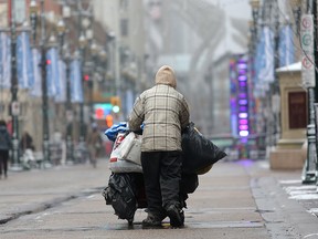 A homeless man pushes his shopping cart on Stephen Avenue Mall in downtown Calgary.